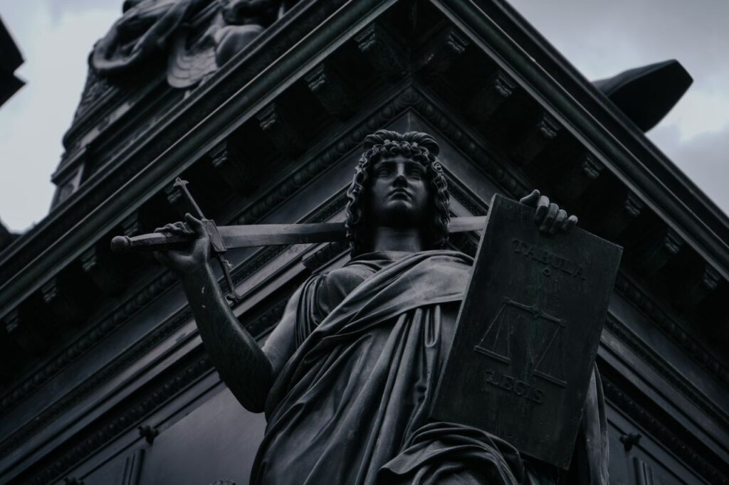 Striking statue of Lady Justice holding sword and scales in Dresden, Germany.